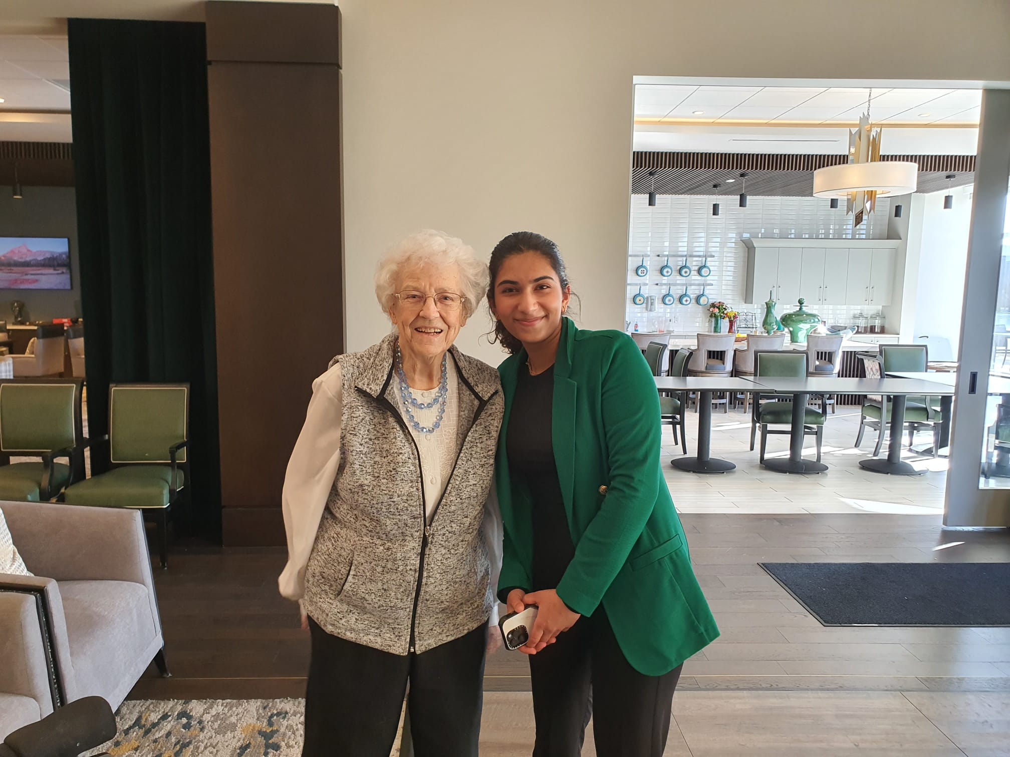 Sophia posing with a senior resident after a performance