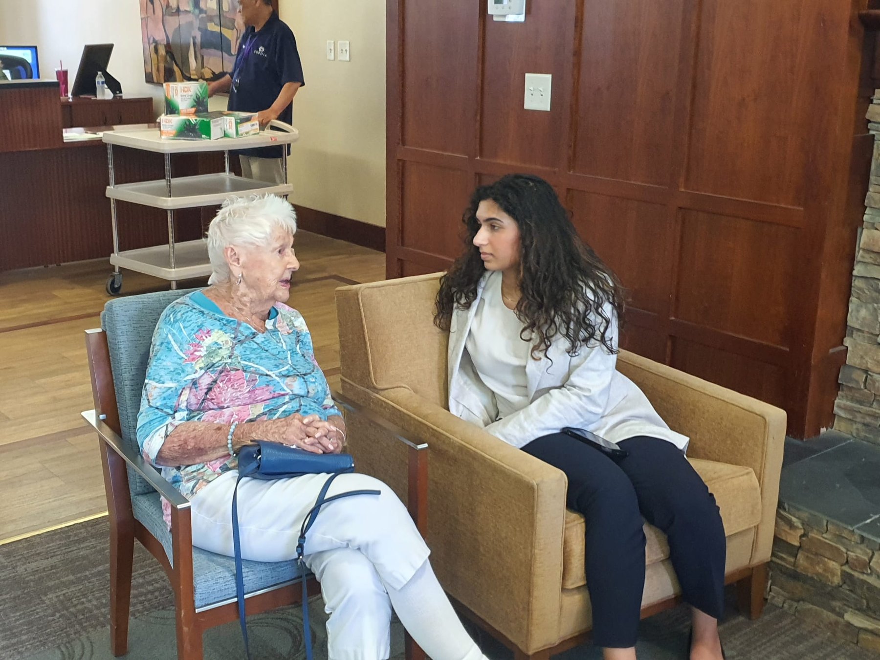 Sophia speaking with a senior living resident