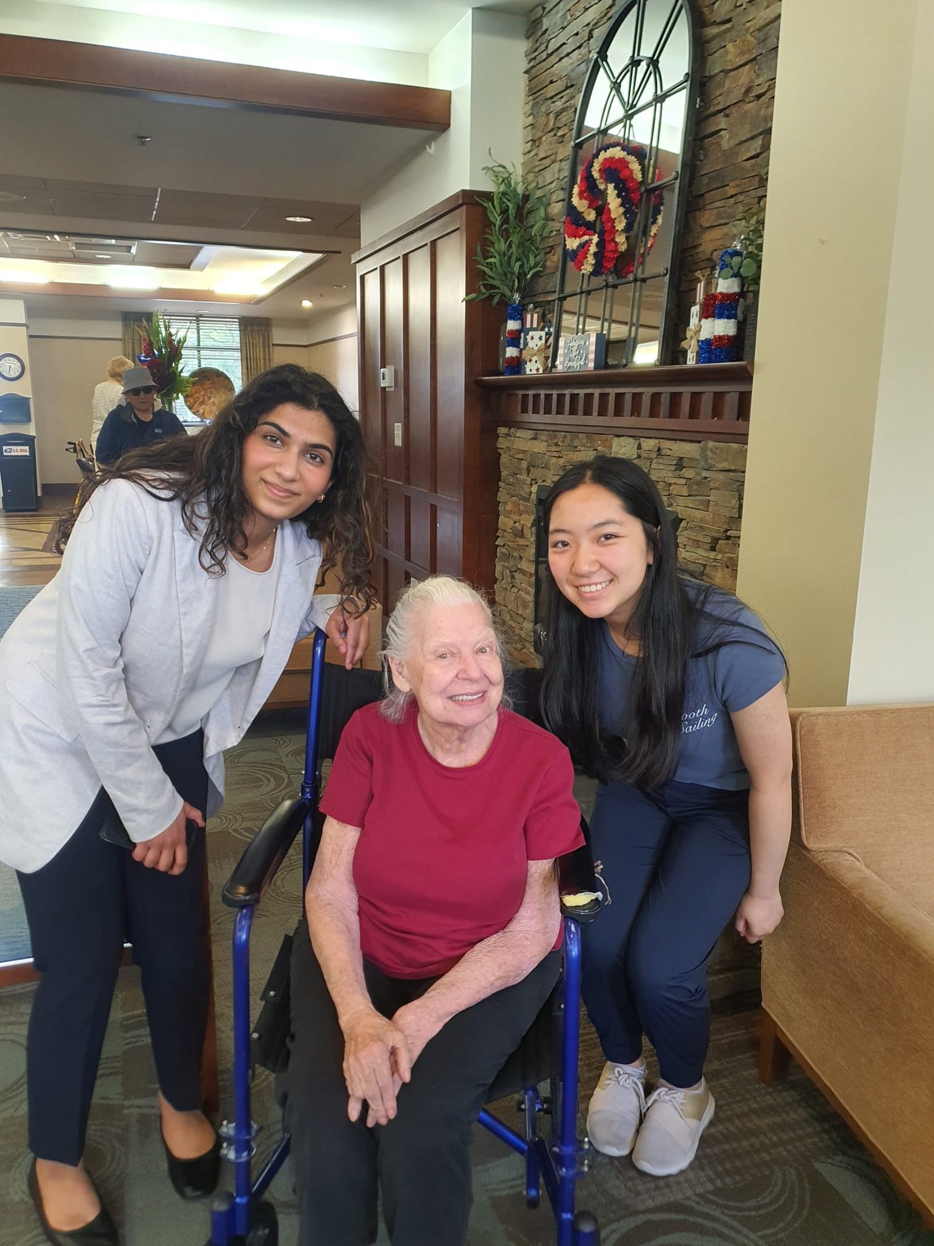 Sophia, a Harmony Healers musician, and a senior living resident smiling together