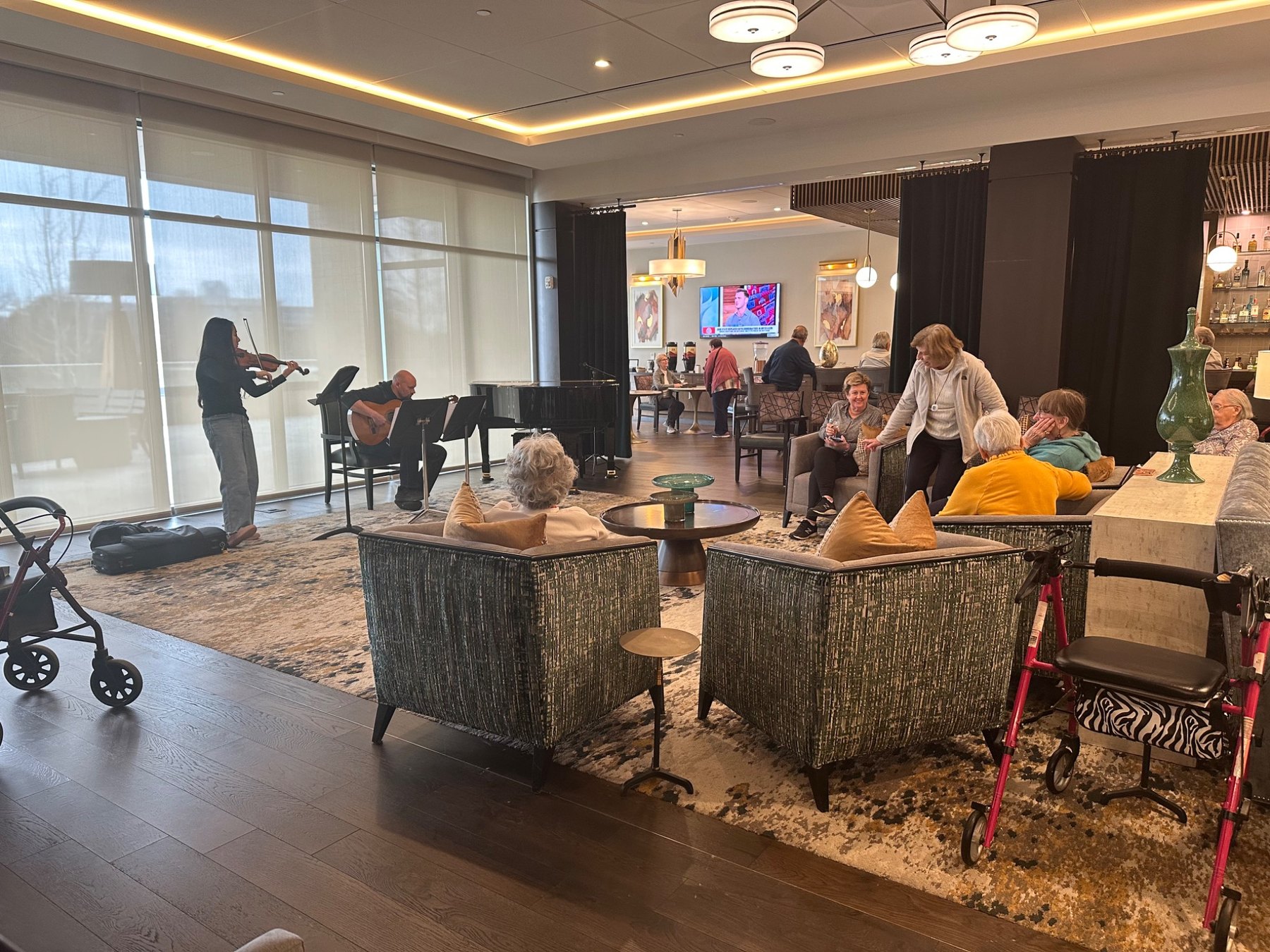 Residents listening to a performance in a senior living space