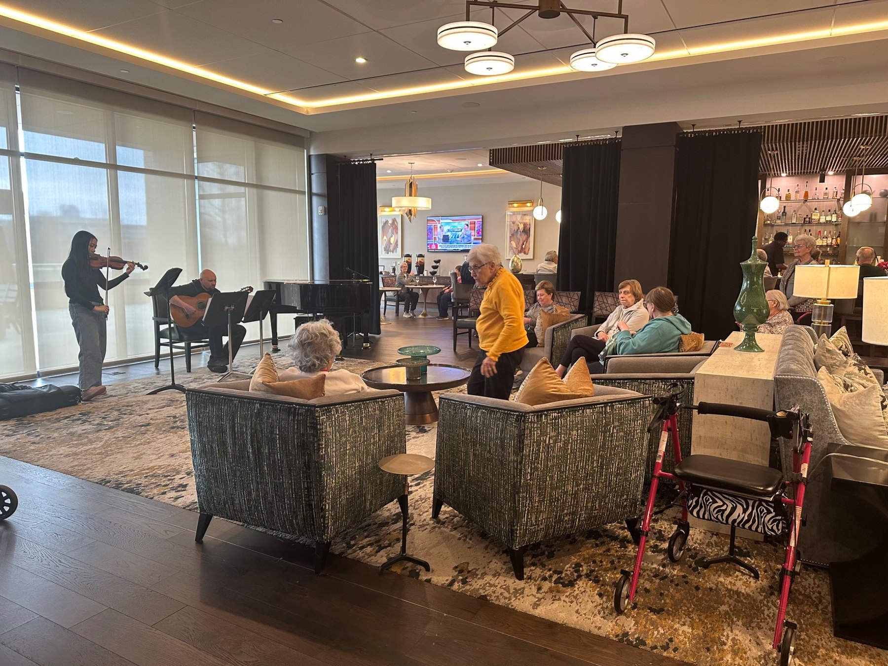 Harmony Healers musicians performing violin and guitar for senior living residents